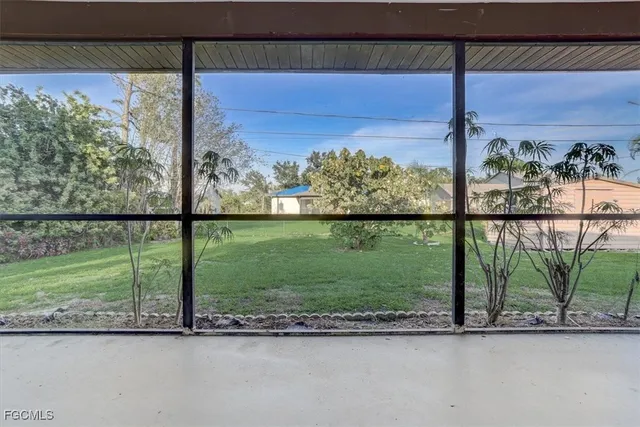 a view of a yard with a street from a window