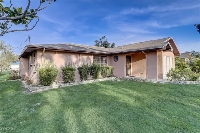 a backyard of a house with plants and garden