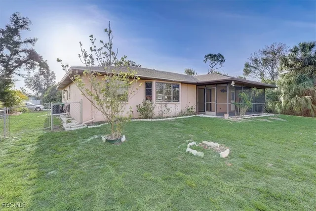 a view of a house with a yard porch and sitting area