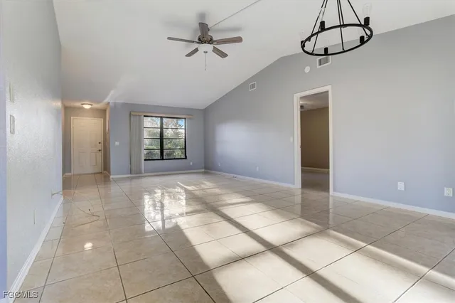 a view of a livingroom with a window and a ceiling fan