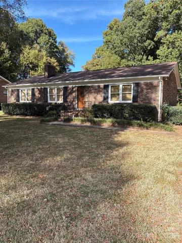 a front view of a house with yard porch and furniture