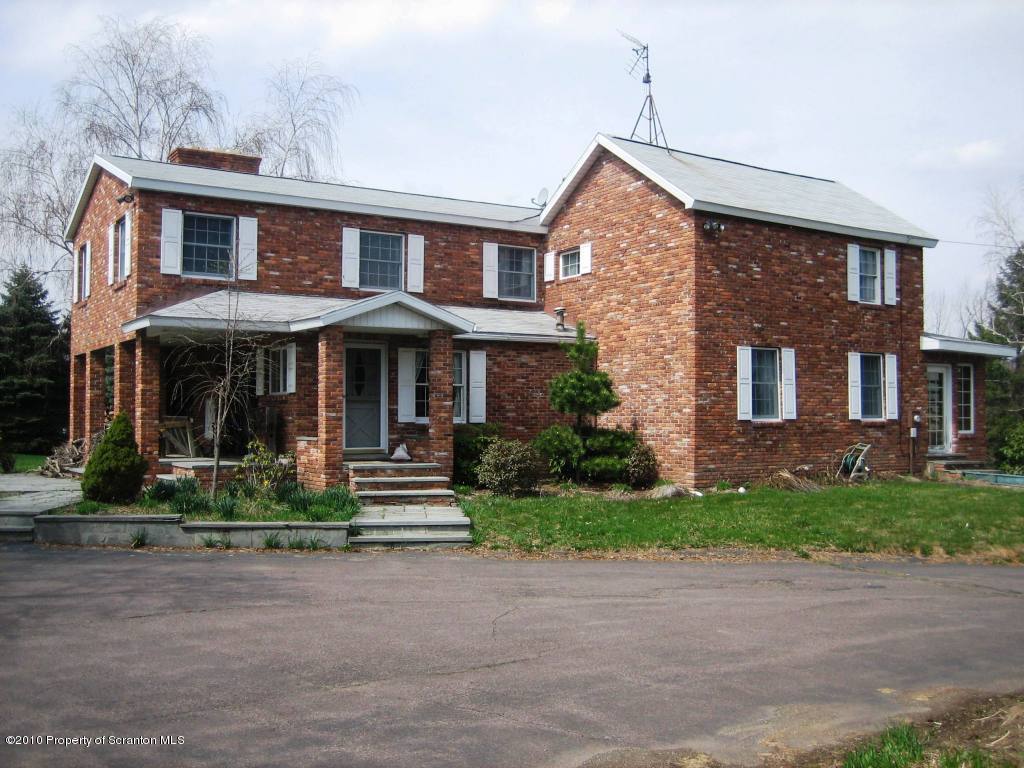 402 Spring Hill Road Moscow, PA 18444 - Photo 1 of 17 a front view of a house with a yard