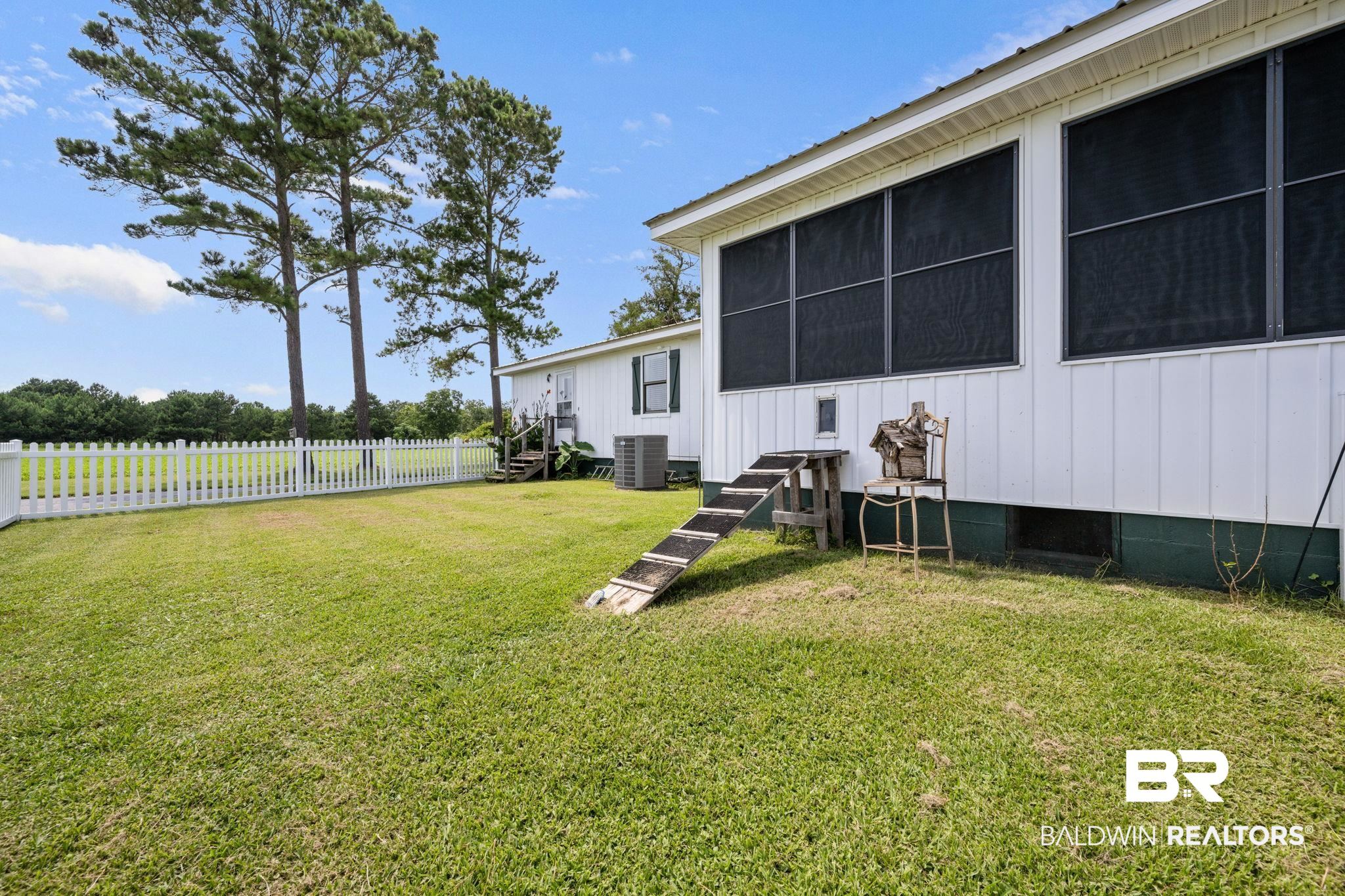 13643 County Road 3 Fairhope, AL 36532 - Photo 9 of 50 Sun room with doggie door and fenced yard