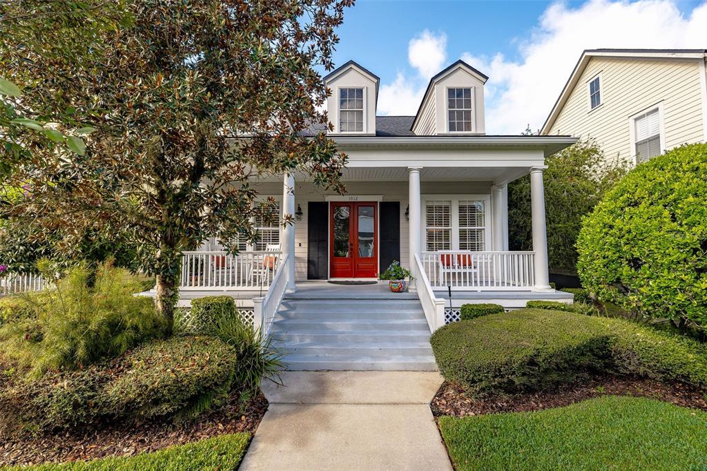 a front view of a house with a garden