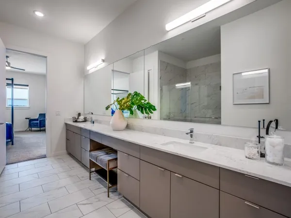 a bathroom with a sink double vanity and a mirror