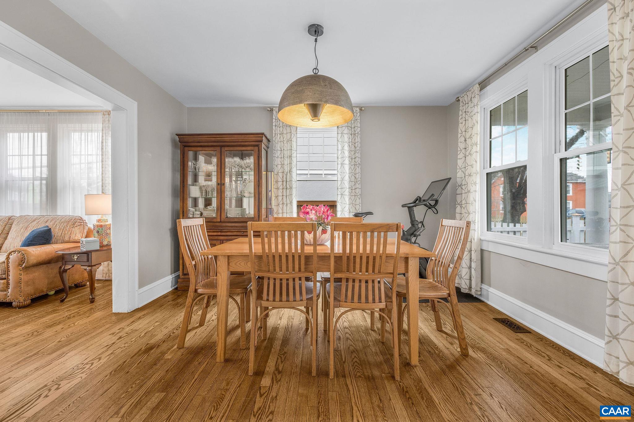 1105 Avon Street Charlottesville, VA 22902 - Photo 12 of 42 a dining room with wooden floor a chandelier a wooden table and chairs