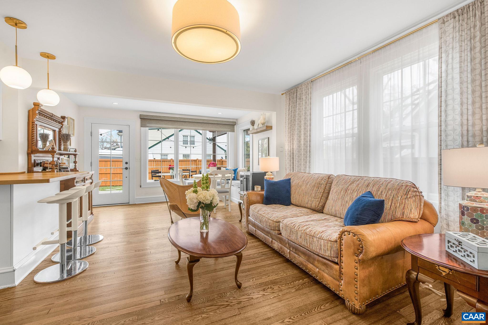 1105 Avon Street Charlottesville, VA 22902 - Photo 16 of 42 a living room with furniture a fireplace and a large window