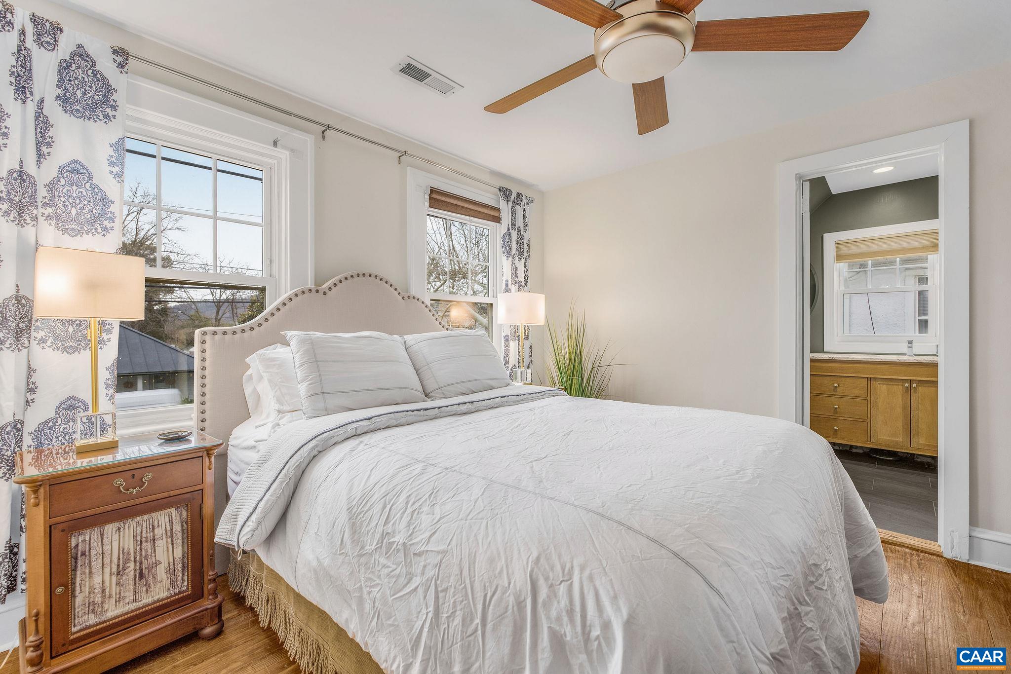 1105 Avon Street Charlottesville, VA 22902 - Photo 32 of 42 a bedroom with a bed and a chandelier