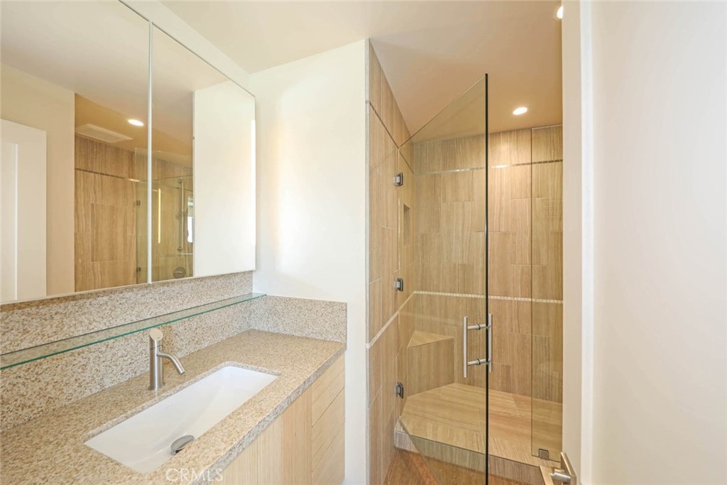 376 Cliff Drive, Unit C Laguna Beach, CA 92651 - Photo 13 of 22 a bathroom with a granite countertop sink a mirror and a shower