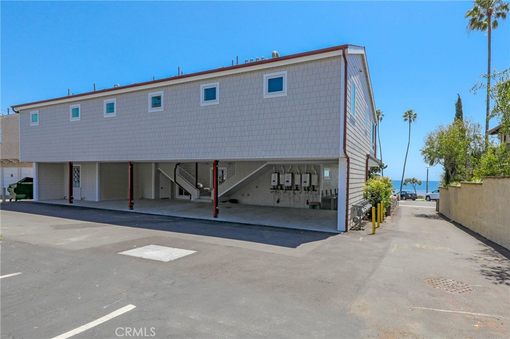 376 Cliff Drive, Unit C Laguna Beach, CA 92651 - Photo 18 of 22 a front view of a house with a yard and garage