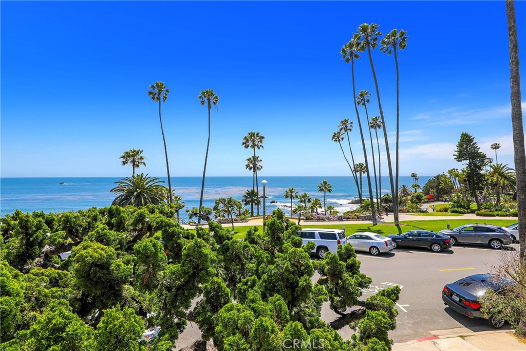 376 Cliff Drive, Unit C Laguna Beach, CA 92651 - Photo 21 of 22 a view of a swimming pool with a table and chairs