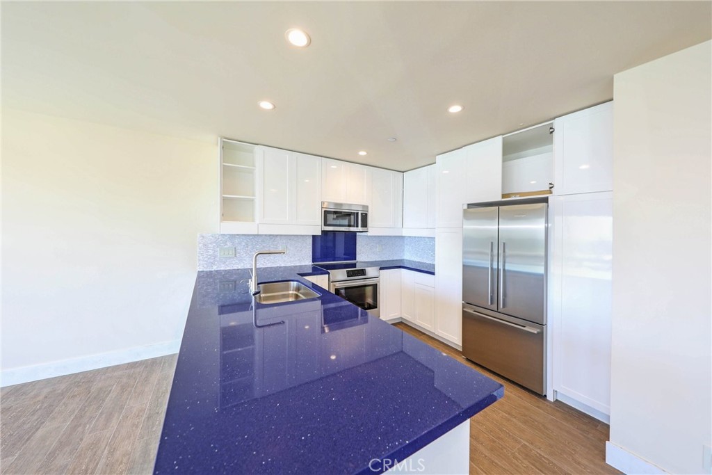 376 Cliff Drive, Unit C Laguna Beach, CA 92651 - Photo 7 of 22 a living room with stainless steel appliances kitchen island furniture and a wooden floor