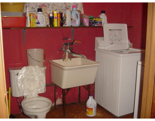 45 Endecott Street Springfield, MA 01118 - Photo 26 of 28 a bathroom with a sink a toilet and a mirror
