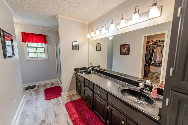 a bathroom with a sink and mirror with window