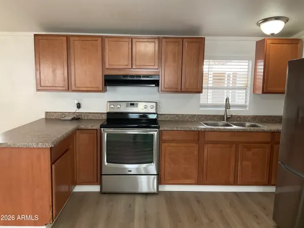 a kitchen with stainless steel appliances granite countertop a sink stove and microwave