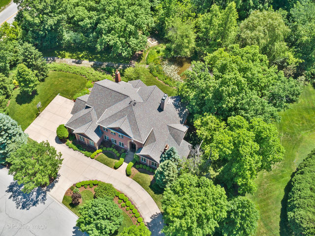 an aerial view of a house with a yard