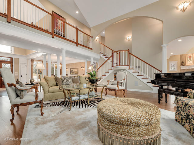20 Ashton Drive Burr Ridge, IL 60527 - Photo 14 of 59 a living room with lots of furniture and a dining table with chandelier