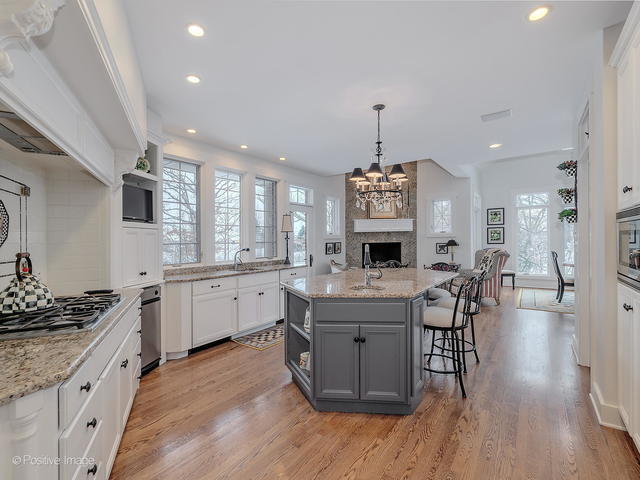 20 Ashton Drive Burr Ridge, IL 60527 - Photo 25 of 59 a large kitchen with granite countertop a stove a sink a dining table and chairs