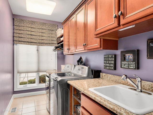 20 Ashton Drive Burr Ridge, IL 60527 - Photo 31 of 59 a kitchen with stainless steel appliances granite countertop a sink a stove and a refrigerator