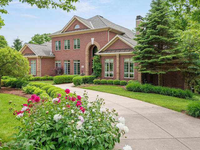 20 Ashton Drive Burr Ridge, IL 60527 - Photo 5 of 59 a front view of a house with lots of flower plants