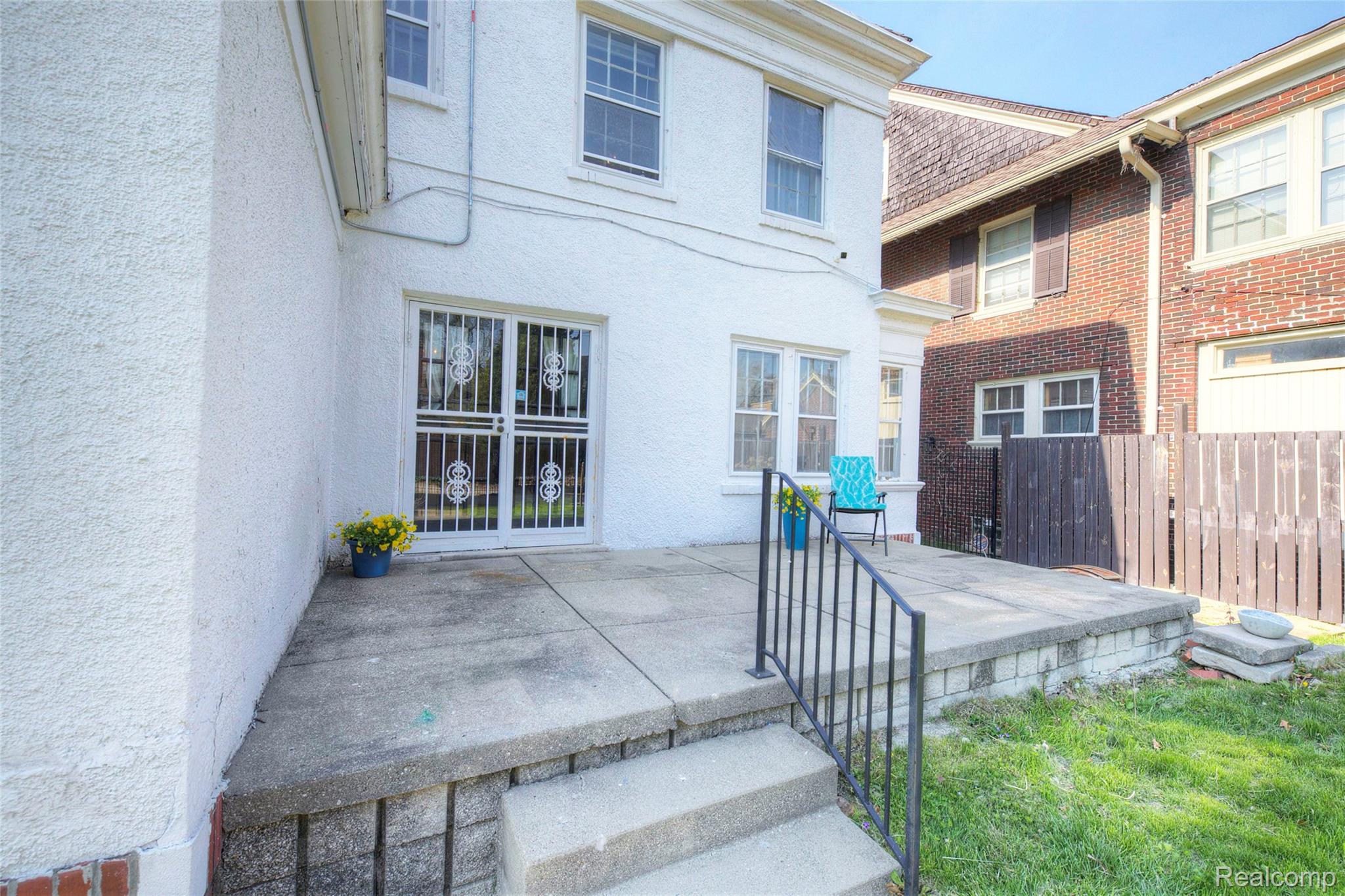 121 Longfellow Street Detroit, MI 48202 - Photo 76 of 87 Rear view of property featuring a patio, brick siding, and stucco siding