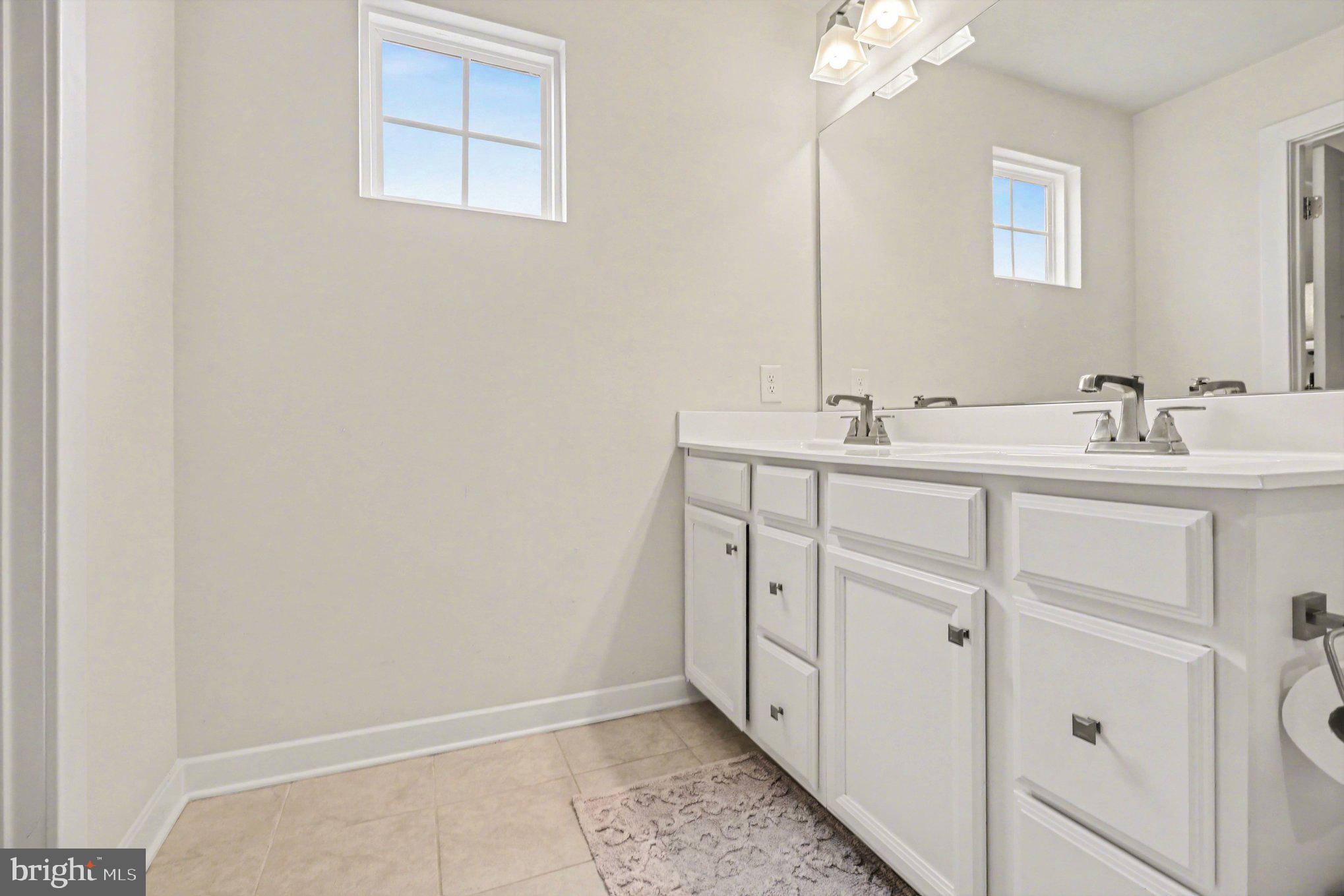 7202 Parchment Circle Ruther Glen, VA 22546 - Photo 22 of 30 a bathroom with a double vanity sink and mirror