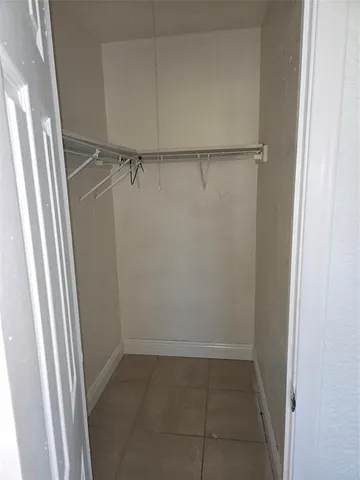 a white toilet sitting next to a bathroom sink and a vanity