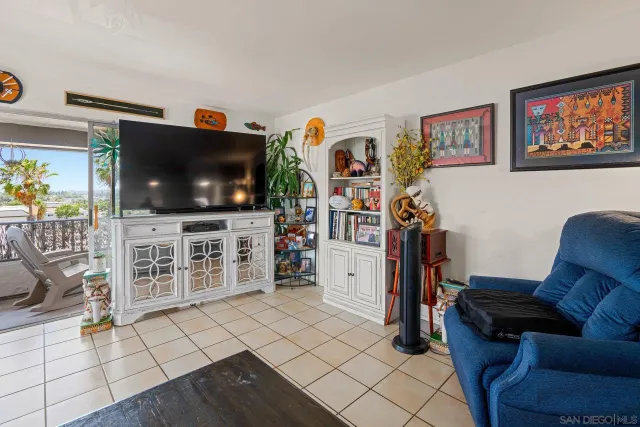 a living room with furniture and a book shelf