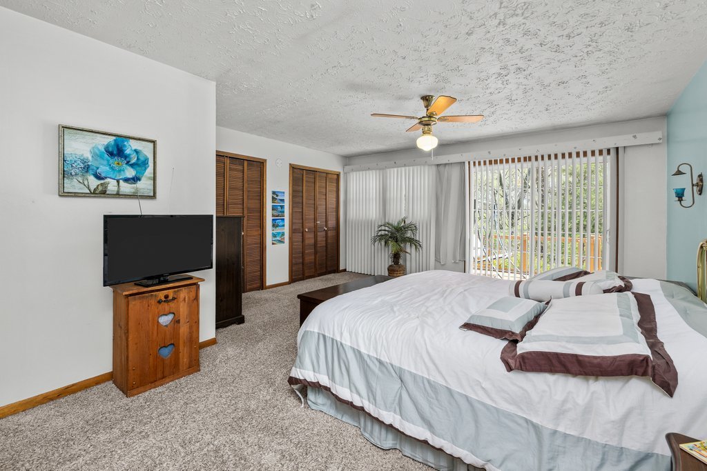 11213 22nd Street Milan, IL 61264 - Photo 16 of 36 a bedroom with a bed and a flat screen tv