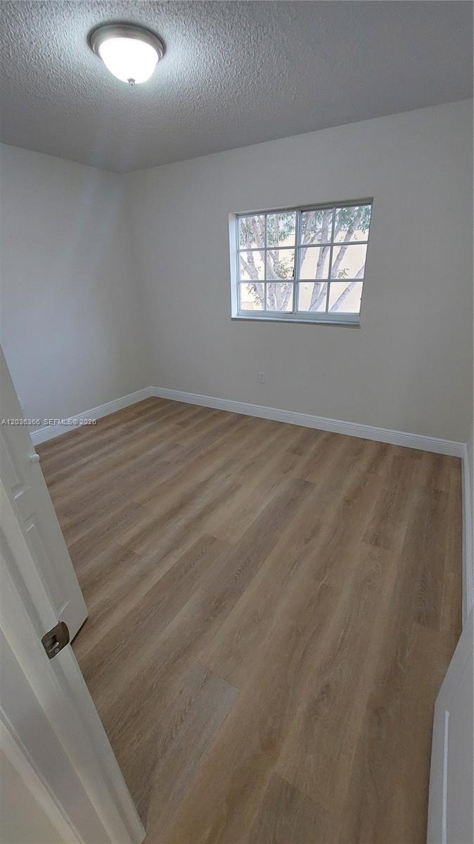 7083 Southwest 158th Court Miami, FL 33193 - Photo 18 of 22 an empty room with windows