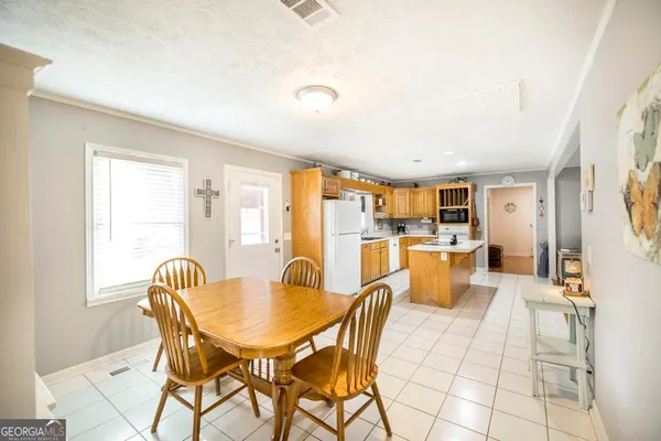 a dining room with furniture and window