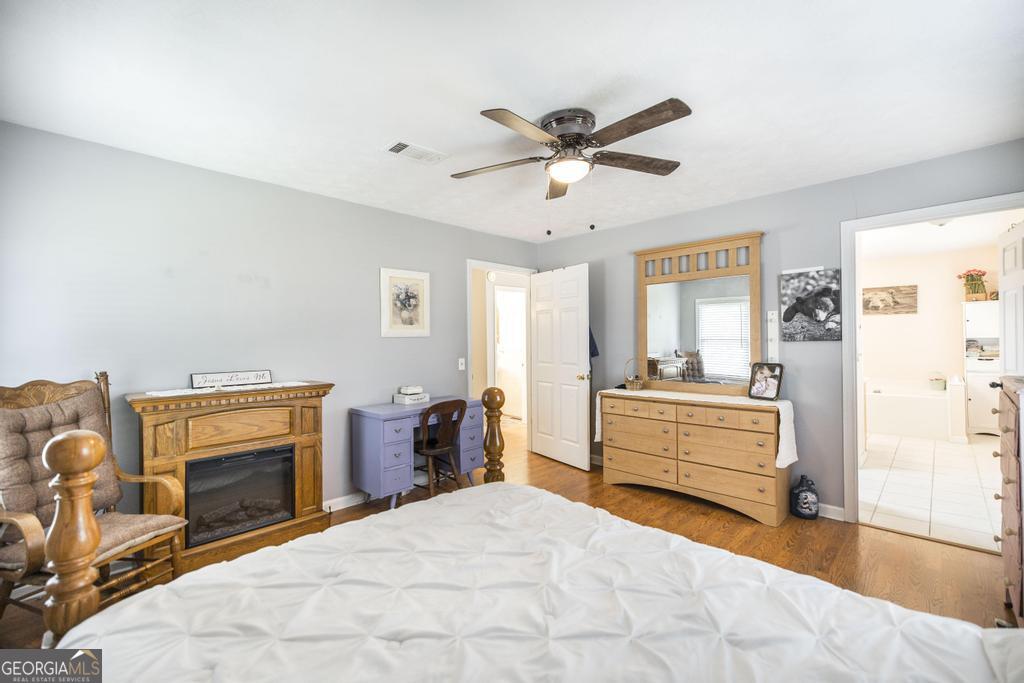 188 Lewis Street Cochran, GA 31014 - Photo 18 of 46 a large bedroom with a bed and wooden floor