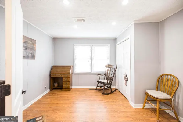 a view of room with furniture and wooden floor