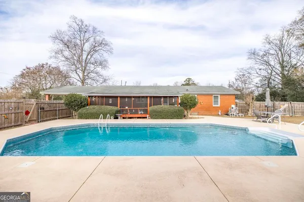 a view of a swimming pool with a patio