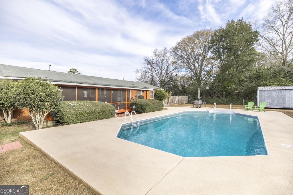188 Lewis Street Cochran, GA 31014 - Photo 32 of 46 a view of a swimming pool with a patio