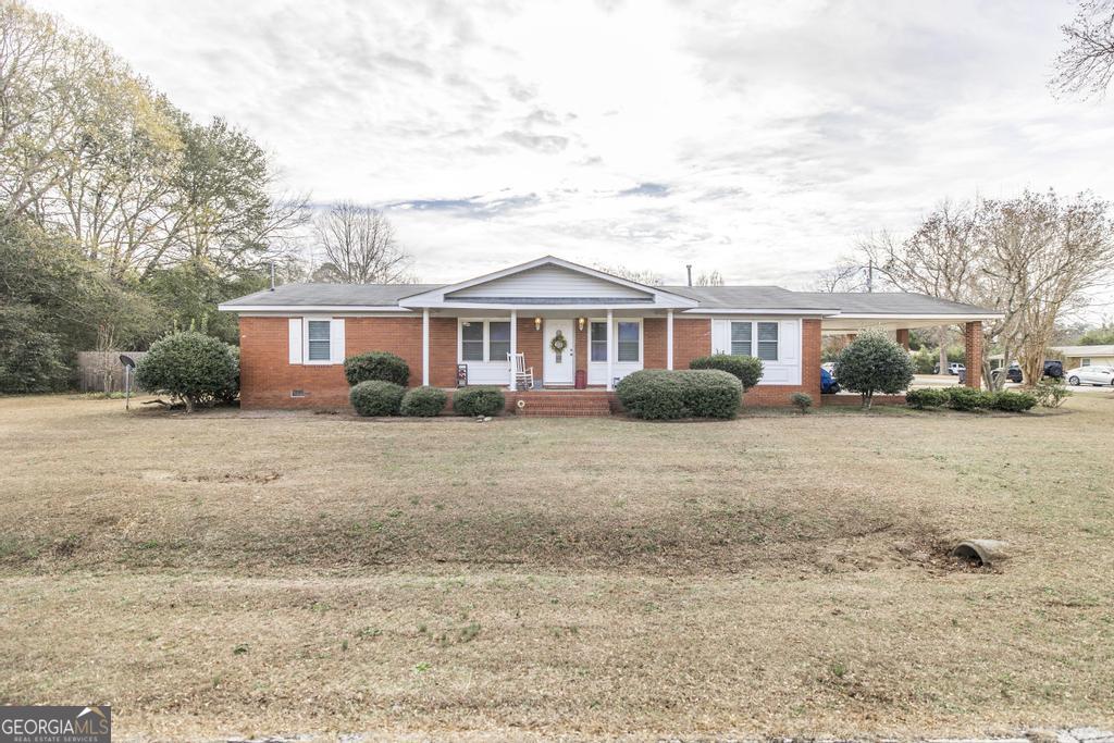 188 Lewis Street Cochran, GA 31014 - Photo 36 of 46 a front view of a house with a yard