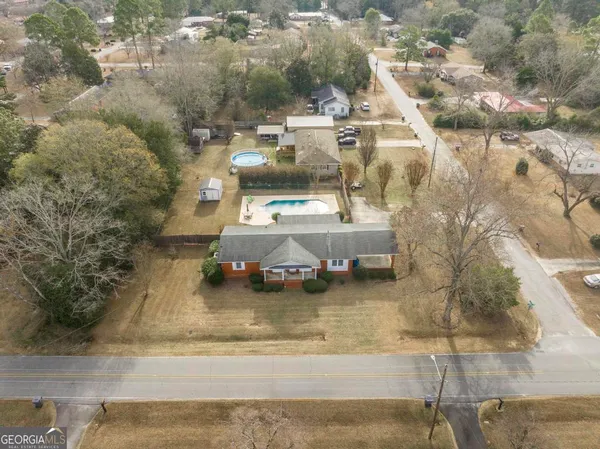 an aerial view of residential houses with outdoor space