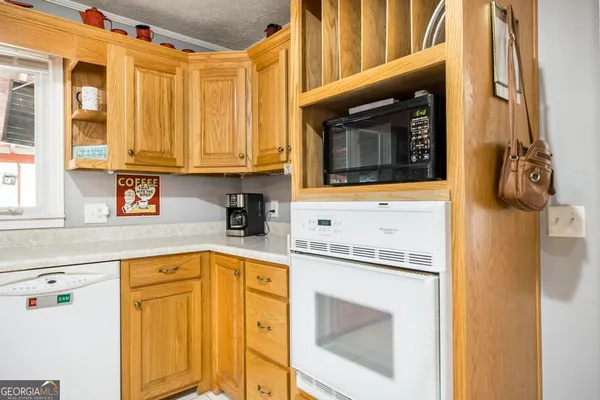 a kitchen with granite countertop cabinets stainless steel appliances and a sink