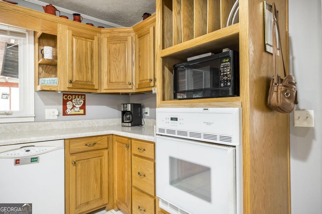188 Lewis Street Cochran, GA 31014 - Photo 8 of 46 a kitchen with granite countertop cabinets stainless steel appliances and a sink