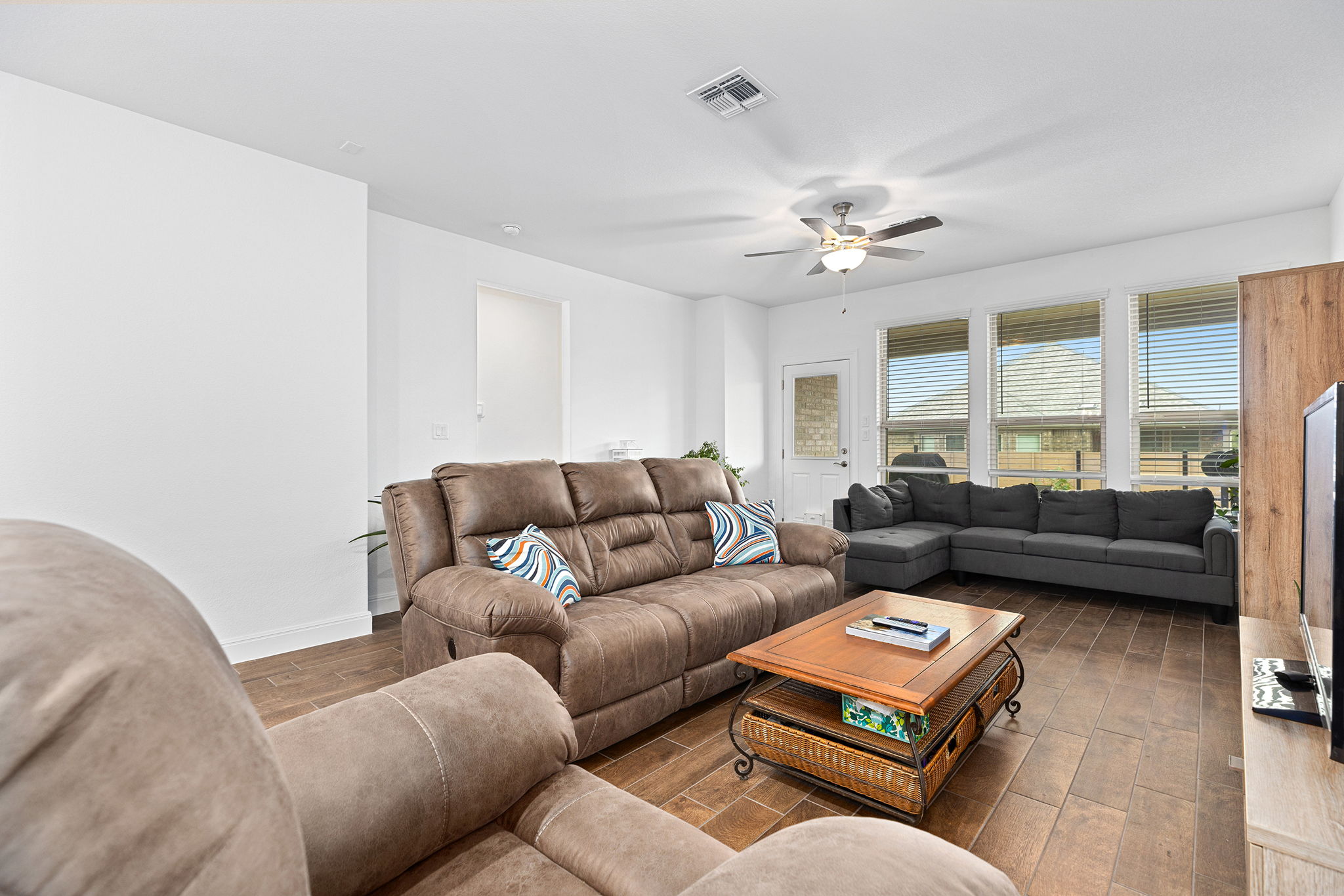 116 Raleigh Drive Georgetown, TX 78633 - Photo 10 of 28 Well-lit living area featuring rich wood-look flooring and a functional ceiling fan.