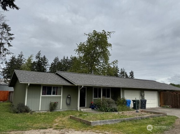 10227-10229 Ainsworth Avenue South Tacoma, WA 98444 - Photo 1 of 23 a view of a house with a yard potted plants and a table and chair