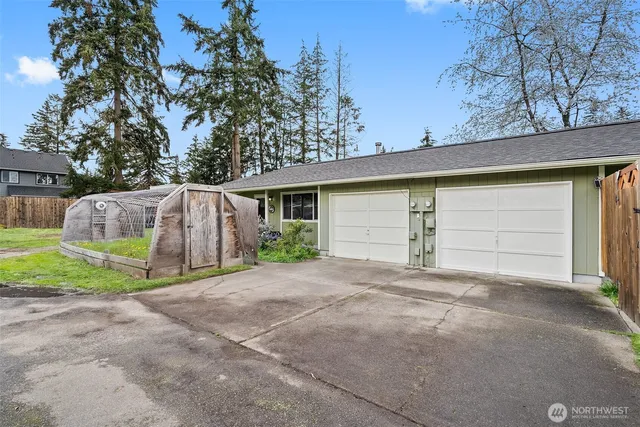 a view of a house with a yard and garage