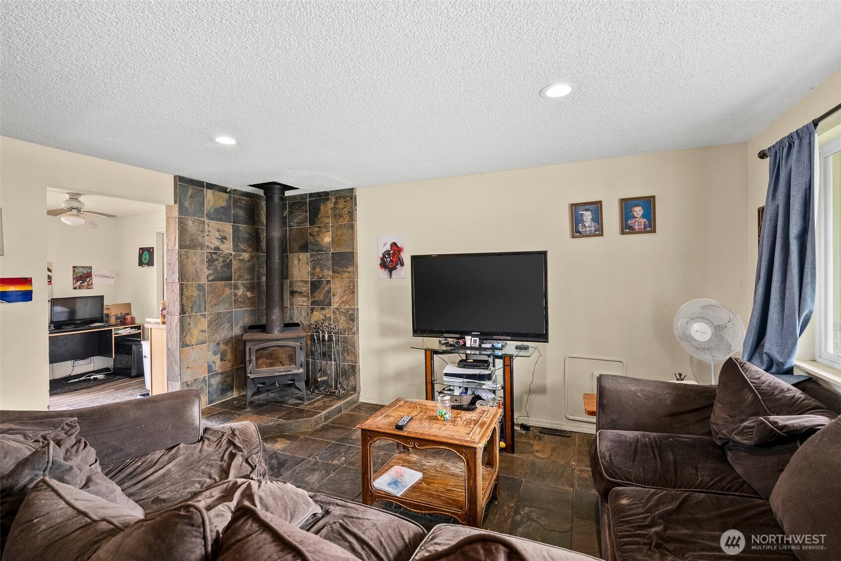 10227-10229 Ainsworth Avenue South Tacoma, WA 98444 - Photo 14 of 23 a living room with furniture and a flat screen tv