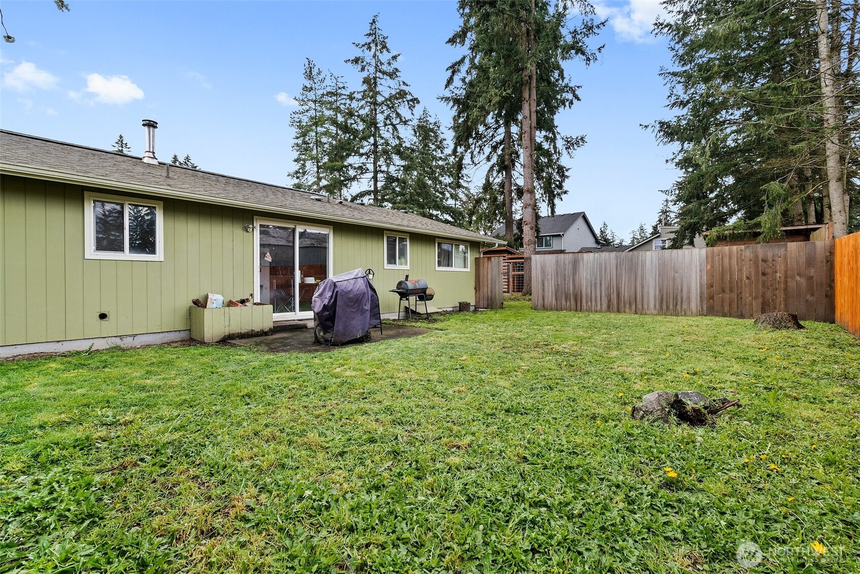10227-10229 Ainsworth Avenue South Tacoma, WA 98444 - Photo 16 of 23 a backyard of a house with table and chairs