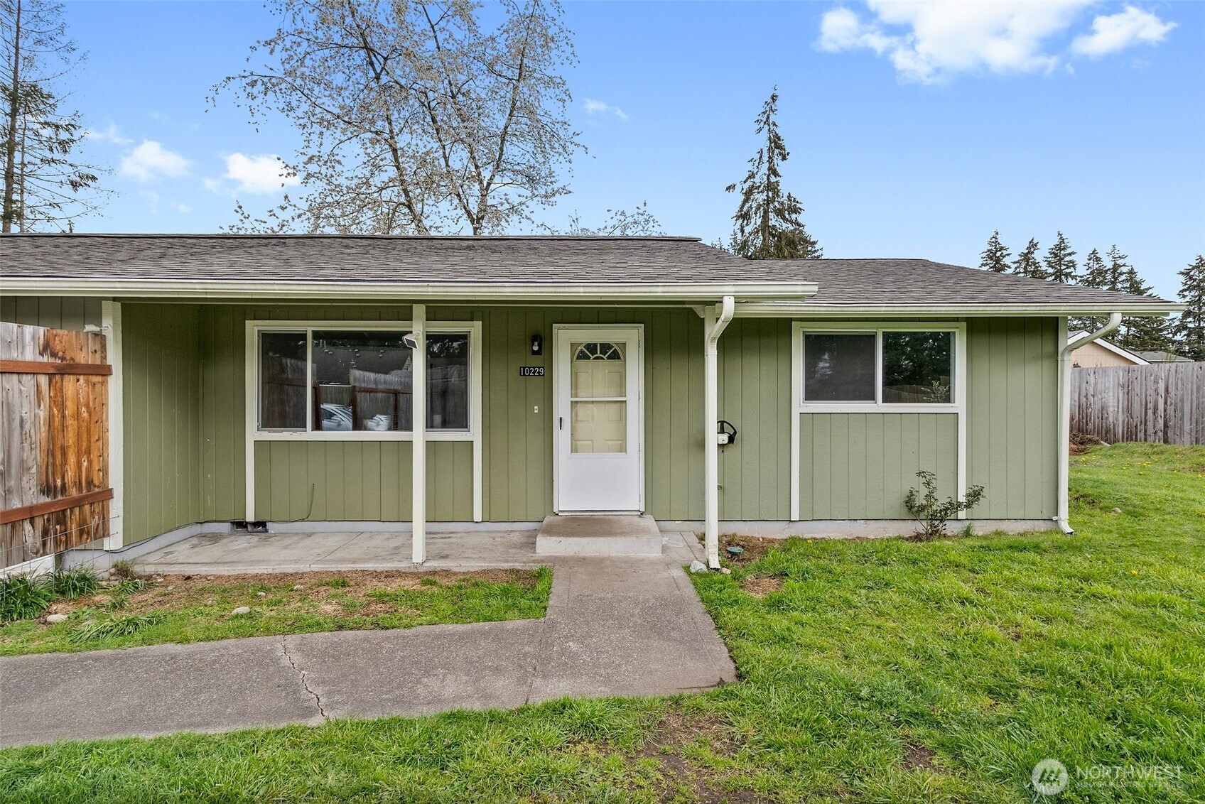 10227-10229 Ainsworth Avenue South Tacoma, WA 98444 - Photo 3 of 23 a front view of a house with garden