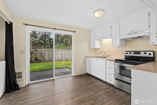 a kitchen with a stove a sink and a refrigerator