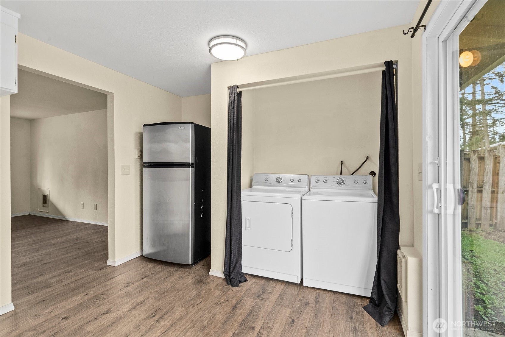 10227-10229 Ainsworth Avenue South Tacoma, WA 98444 - Photo 9 of 23 a view of washer and dryer with wooden floor