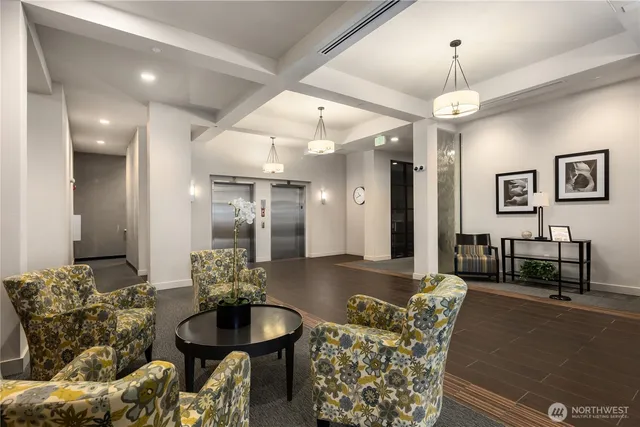 a living room with furniture and a chandelier