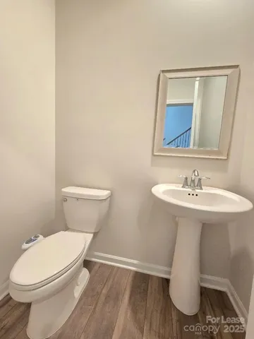 a white toilet sitting next to a bathroom sink