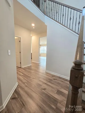 a view of hallway with wooden floor